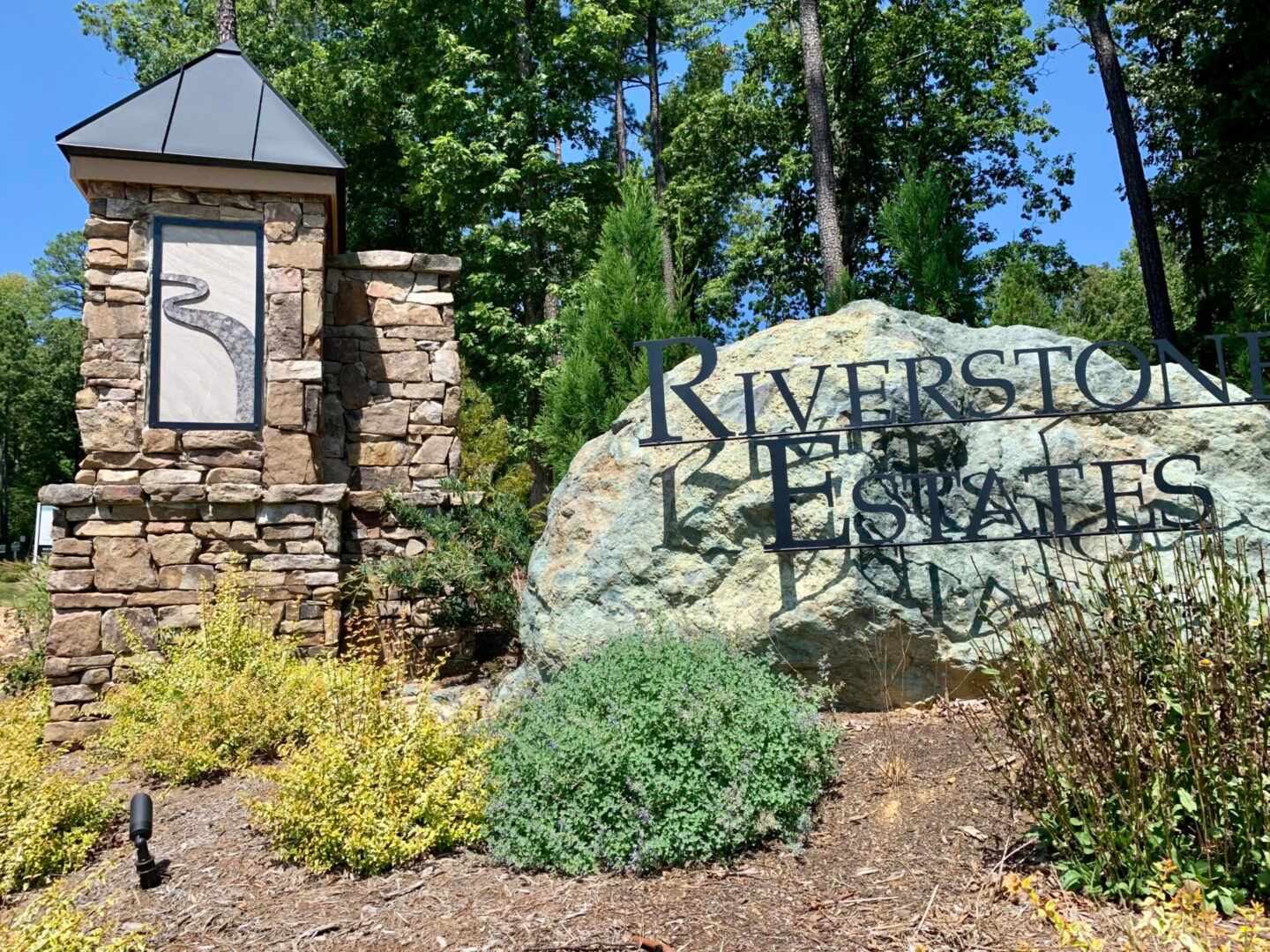 River Stone Estates Name and a Rock Behind it