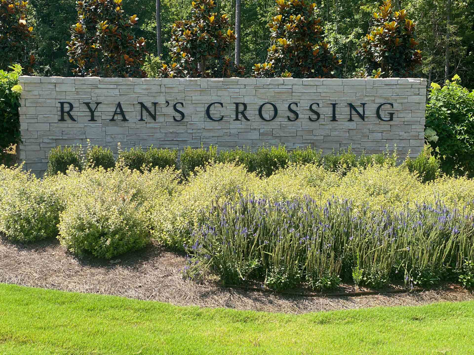 Ryans Crossing Name On a Wall and Bushes Around
