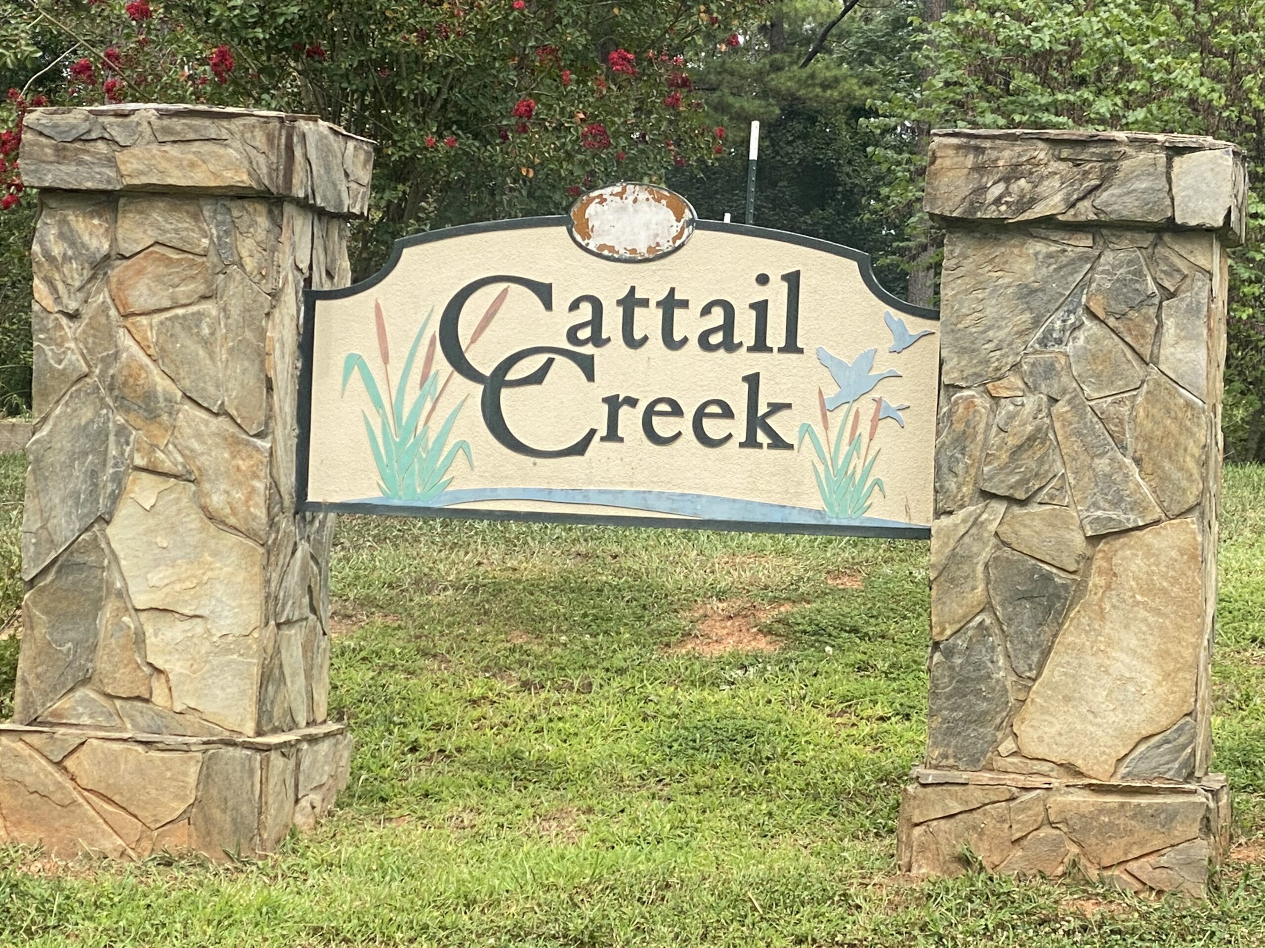 Cattail Creek Board on Stone With Black Lettering